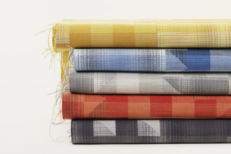 A stack of primary colored textiles on a white background.
