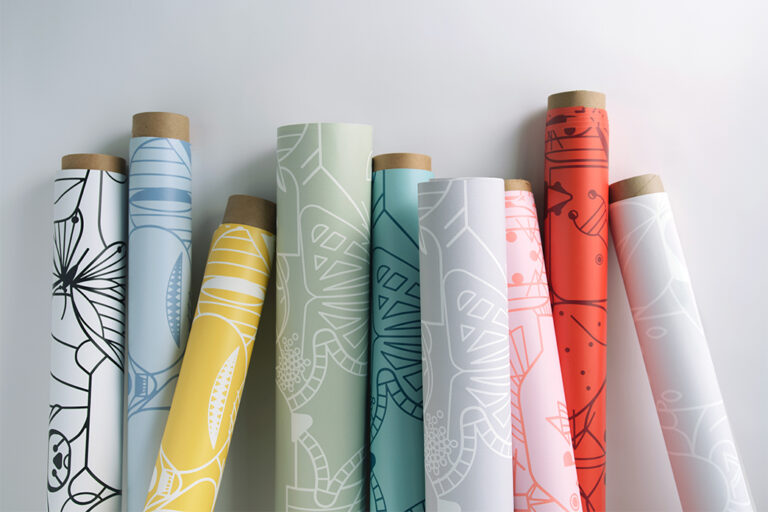 Wallcovering rolls in various colors with an animal outline pattern standing on end in various angles.