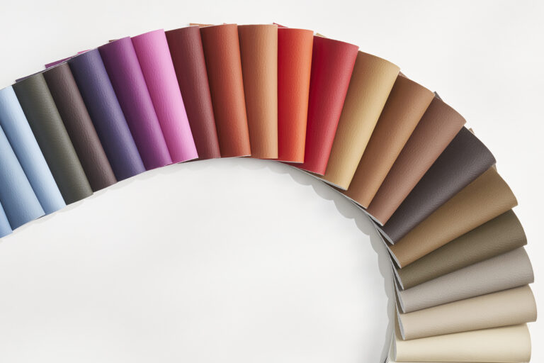 Snake of silicone fabric swatches on a white table.