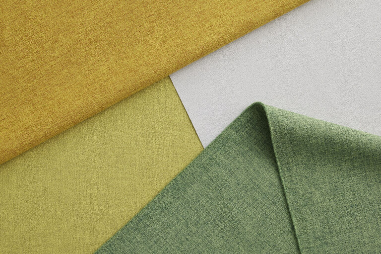 Folded fabrics on a white table.