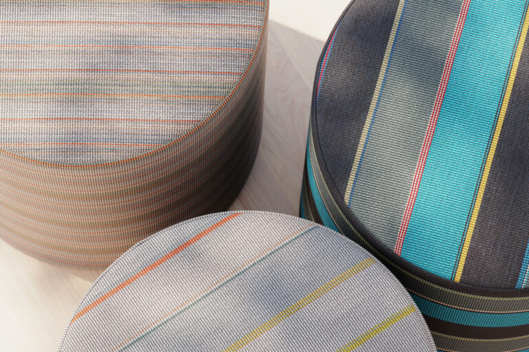 3 poufs upholstered with striped textiles